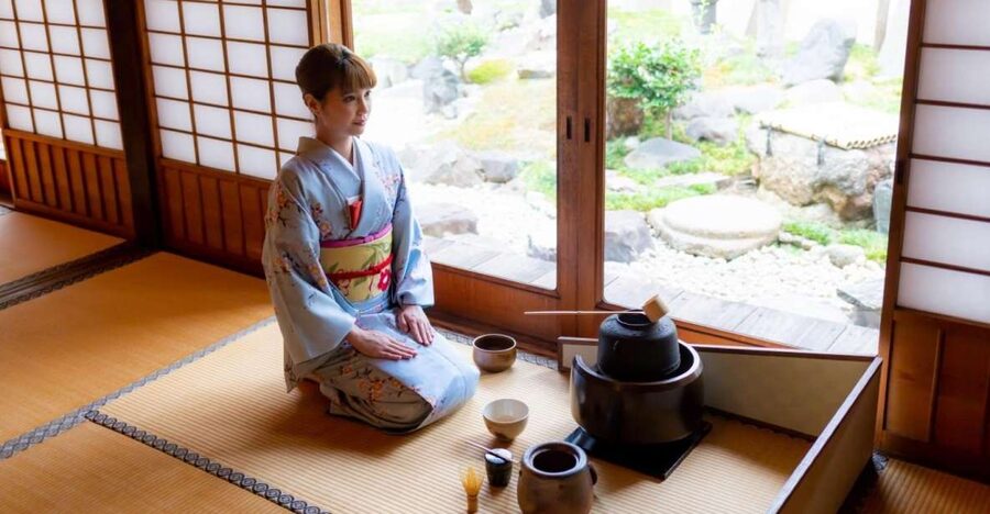 A host preparing matcha on tatami in a Kyoto tea room